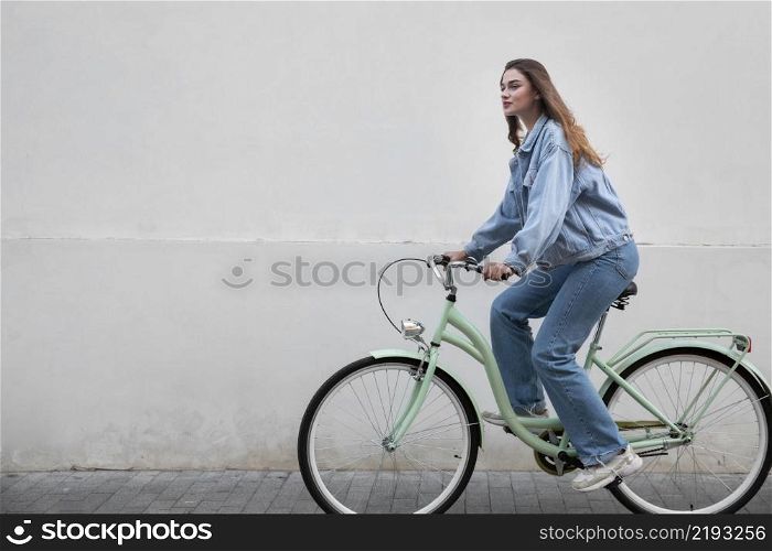 side view woman riding her bike
