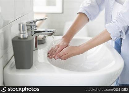 side view woman using water wash her hands