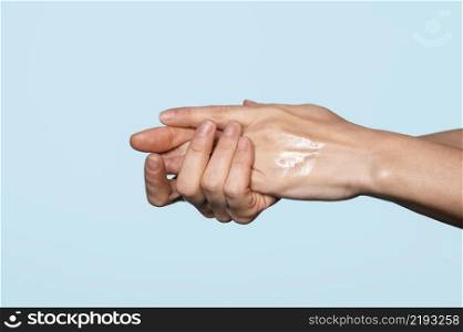 side view woman washing hands isolated blue