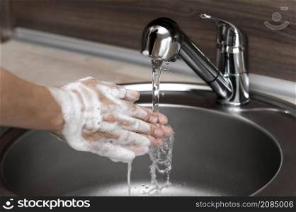 side view woman washing hands sink