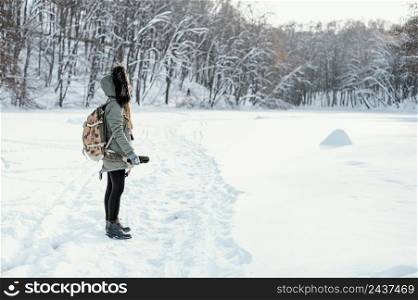 side view woman with backpack winter day