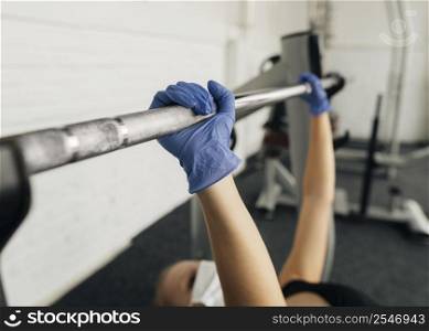 side view woman with gloves medical mask working out gym