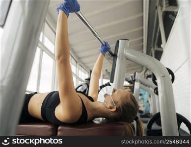 side view woman with gloves working out gym