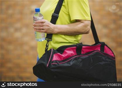 side view woman with sports bag