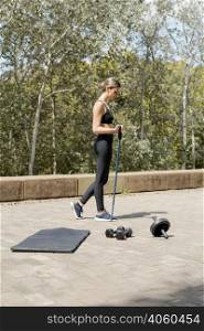 side view woman with training equipment outdoors