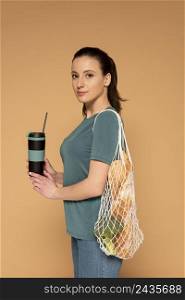side view woman with turtle bag thermos