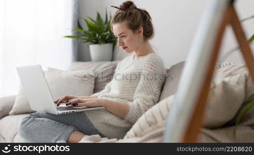 side view woman writing blog home