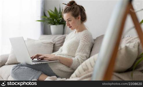 side view woman writing blog home