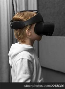 side view young boy using virtual reality headset