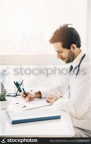 side view young male doctor writing clipboard clinic