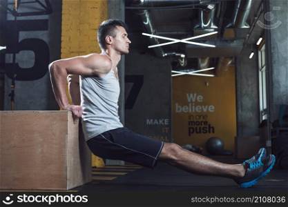 side view young man exercising gym