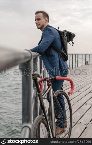 side view young man standing his bike outdoors