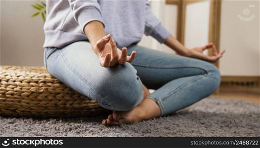 side view young woman doing yoga home