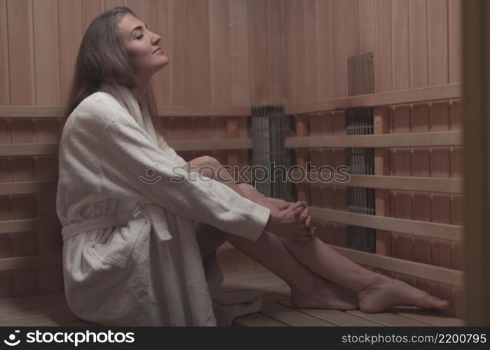 side view young woman sitting wooden bench sauna