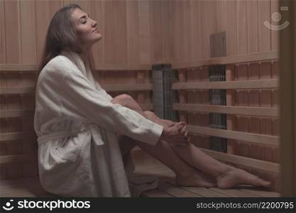 side view young woman sitting wooden bench sauna