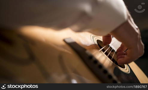 sideways close up man person playing guitar . Resolution and high quality beautiful photo. sideways close up man person playing guitar . High quality and resolution beautiful photo concept