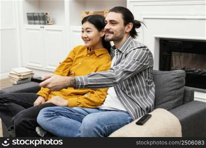 sideways couple sitting couch watching tv