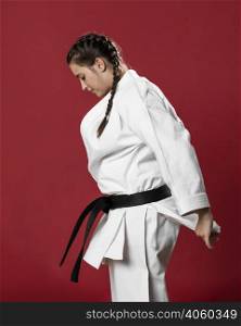 sideways karate woman traditional white kimono red background
