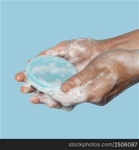 sideways person holding blue soap close up