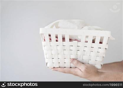 sideways person holding laundry basket