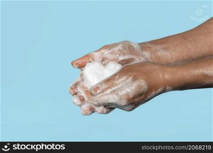 sideways person washing hands with white soap