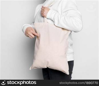 sideways woman carrying fabric tote bag . Resolution and high quality beautiful photo. sideways woman carrying fabric tote bag . High quality and resolution beautiful photo concept