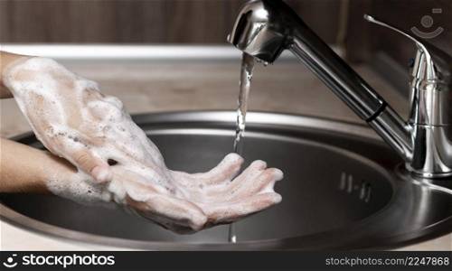 sideways woman washing hands sink