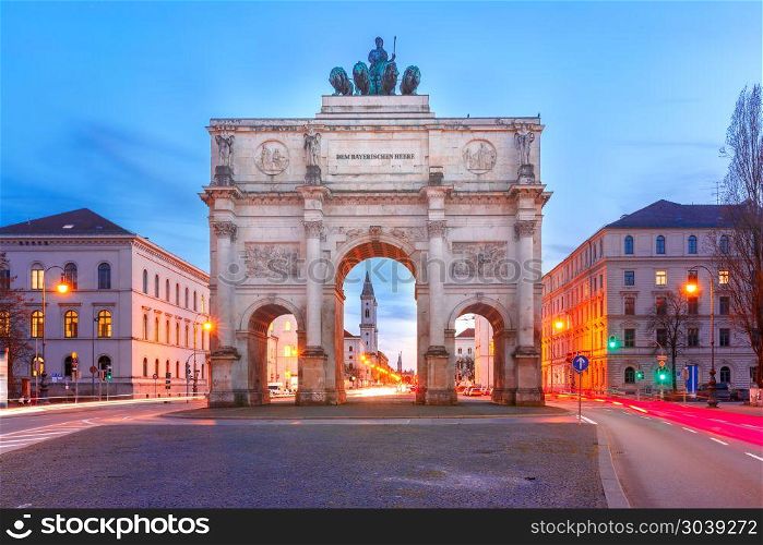 Siegestor, Victory Gate at night, Munich, Germany. The Siegestor or Victory Gate, triumphal arch crowned with a statue of Bavaria with a lion-quadriga, during evening blue hour in Munich, Germany