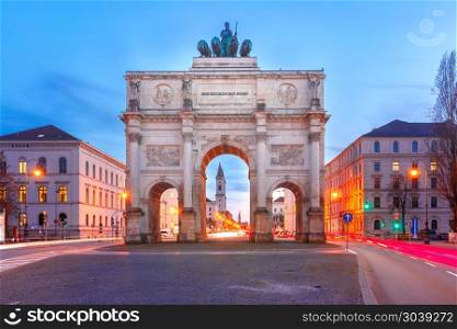 Siegestor, Victory Gate at night, Munich, Germany. The Siegestor or Victory Gate, triumphal arch crowned with a statue of Bavaria with a lion-quadriga, during evening blue hour in Munich, Germany