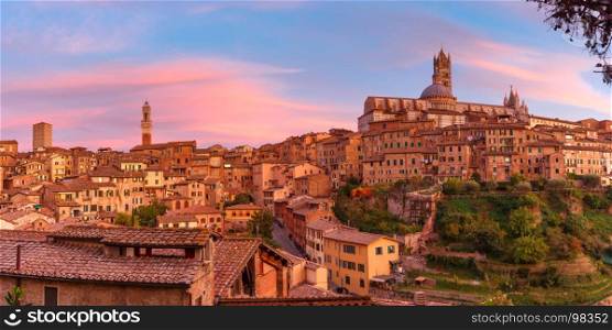 Siena Cathedral at gorgeous sunset, Tuscany, Italy. Beautiful panoramic view of Old Town with Dome and campanile of Siena Cathedral, Duomo di Siena, and Mangia Tower or Torre del Mangia at gorgeous sunset, Siena, Tuscany, Italy