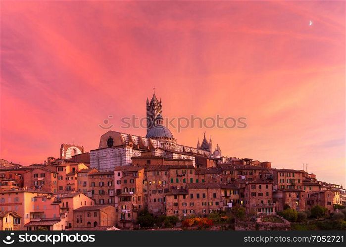 Siena Cathedral at gorgeous sunset, Tuscany, Italy. Beautiful view of Dome and campanile of Siena Cathedral, Duomo di Siena, and Old Town of medieval city of Siena at gorgeous sunset, Tuscany, Italy