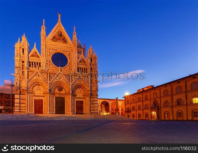 Siena. Cathedral at sunset.. View of the Cathedral in the night illumination at sunset. Siena. Tuscany. Italy.