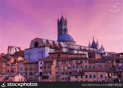 Siena. Cathedral at sunset.. View of the Cathedral in the night illumination at sunset. Siena. Tuscany. Italy.