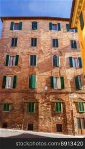 Siena. Facades of old houses.. Facades old medieval houses in the historical part of the city. Siena. Tuscany. Italy.
