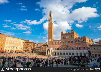 SIENA, ITALY - OCT 21, 2017  Crowd of people in Piazza del C&o square in Siena, Italy. It is renowned worldwide for its beauty and architectural integrity