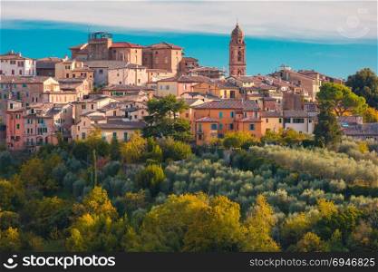 Siena Old Town in the sunny day, Tuscany, Italy. Beautiful view of church and Old Town of medieval city of Siena in the sunny day through autumn leaves, Tuscany, Italy