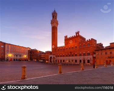 Siena. The central city square piazza del Campo.. Facades of medieval buildings on Piazza del Campo at night. Siena. Tuscany. Italy.