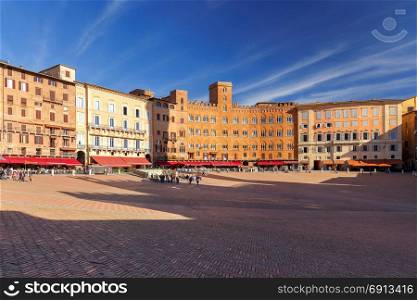Siena. The central city square piazza del Campo.. Multicolored facades of medieval buildings on Piazza del Campo. Siena. Tuscany. Italy.
