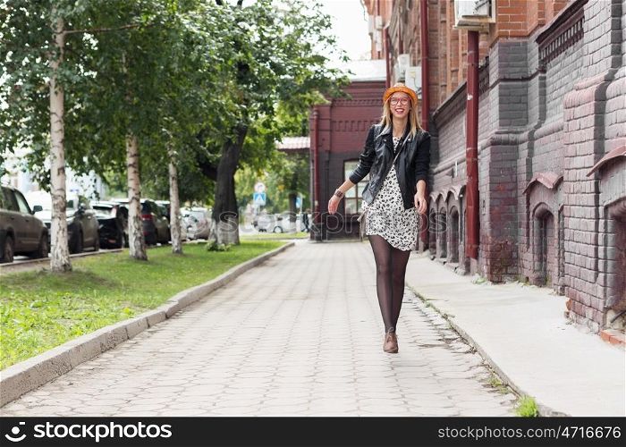 Sightseeing in touristic city. Happy tourist girl walking on city historic street