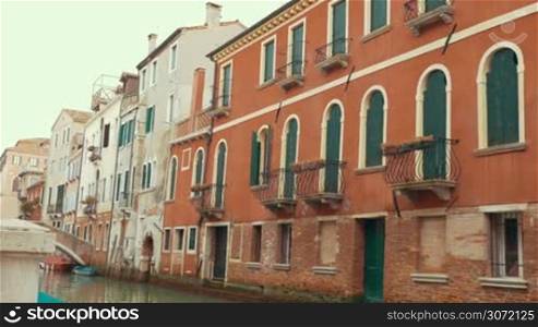 Sightseeing of Venice, Italy. Steadicam shot of city view with quiet canal and old style architecture