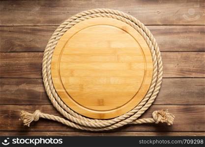 sign board and ship rope at wooden background texture