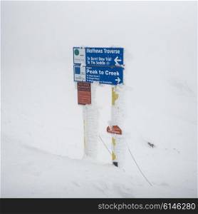 Sign board in snowy valley, Whistler, British Columbia, Canada