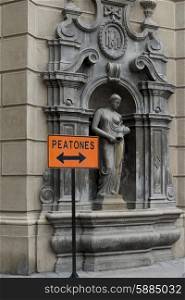 Sign in front of carving wall, Santiago, Santiago Metropolitan Region, Chile