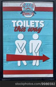 Sign indicating the way to the nearst local public toilets