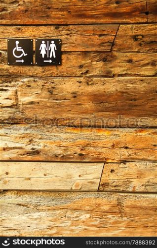 Sign of public toilets WC on wooden wall background