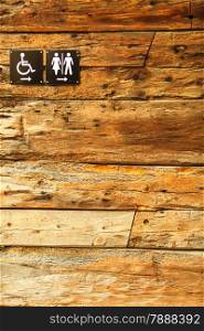 Sign of public toilets WC on wooden wall background