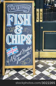 Sign on blackboard outside a pub in London promoting their Ultimate Fish and Chips, a great British favourite. Sign on blackboard outside a pub in London promoting their Ultimate Fish and Chips, a great British favourite.