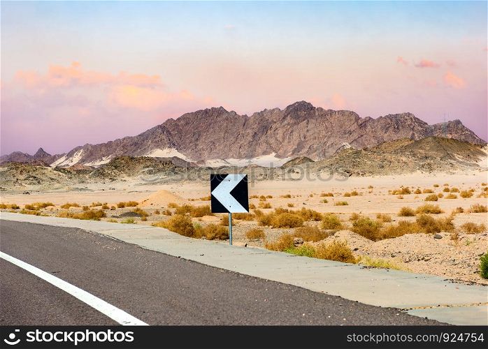 Sign on road in the desert of Egypt at sunset. Sign on road in Egypt