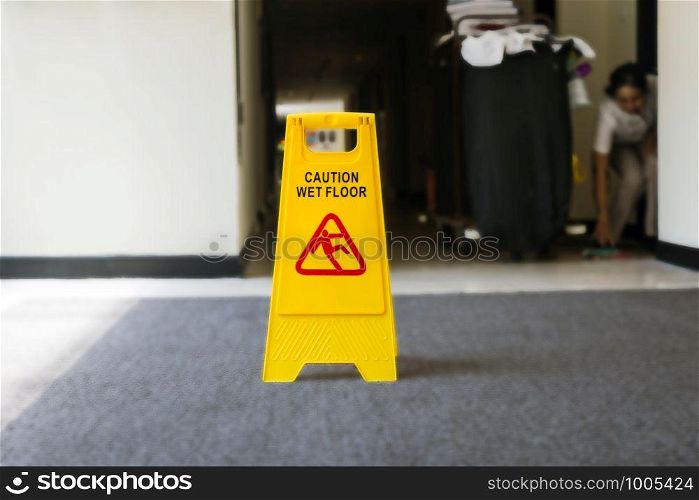 Sign showing warning of caution wet floor, cleaner on the background yellow. Sign showing warning of caution wet floor, cleaner on the background