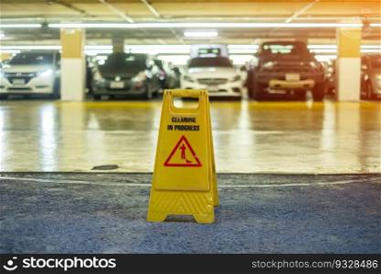 Sign showing warning of caution wet floor in garage building